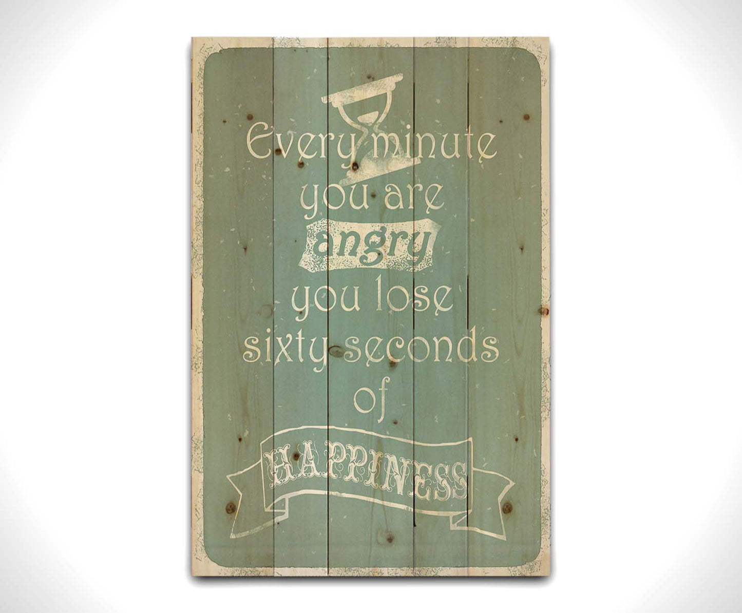 A typography design reading "Every minute you are angry you lose sixty seconds of happiness" in white on a blue background. Printed on a wood pallet.