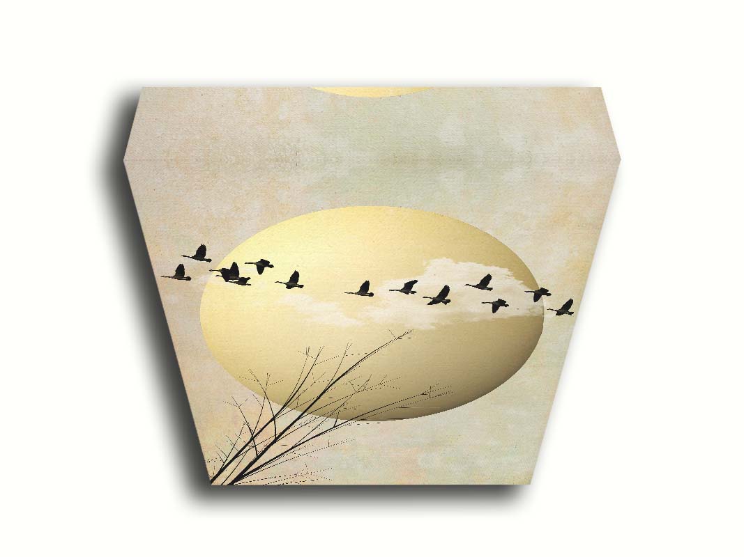 A photo collage art piece of migratory birds flying south for the winter, silhouetted against a big gold moon. Printed on canvas.