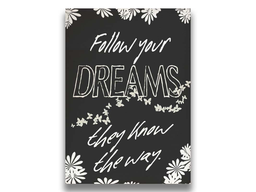 A typography design with flowers and butterflies. It reads "Follow your dreams, they know the way," in white on a black background. Printed on canvas.