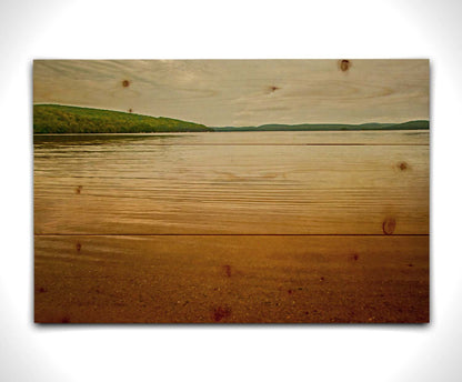 A painting of the orange sunlight reflecting off the ocean. Printed on a wood pallet.