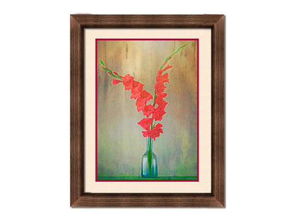 A photo of two red gladiolus flower spikes in a small blue vase. Printed on paper, matted, and framed.