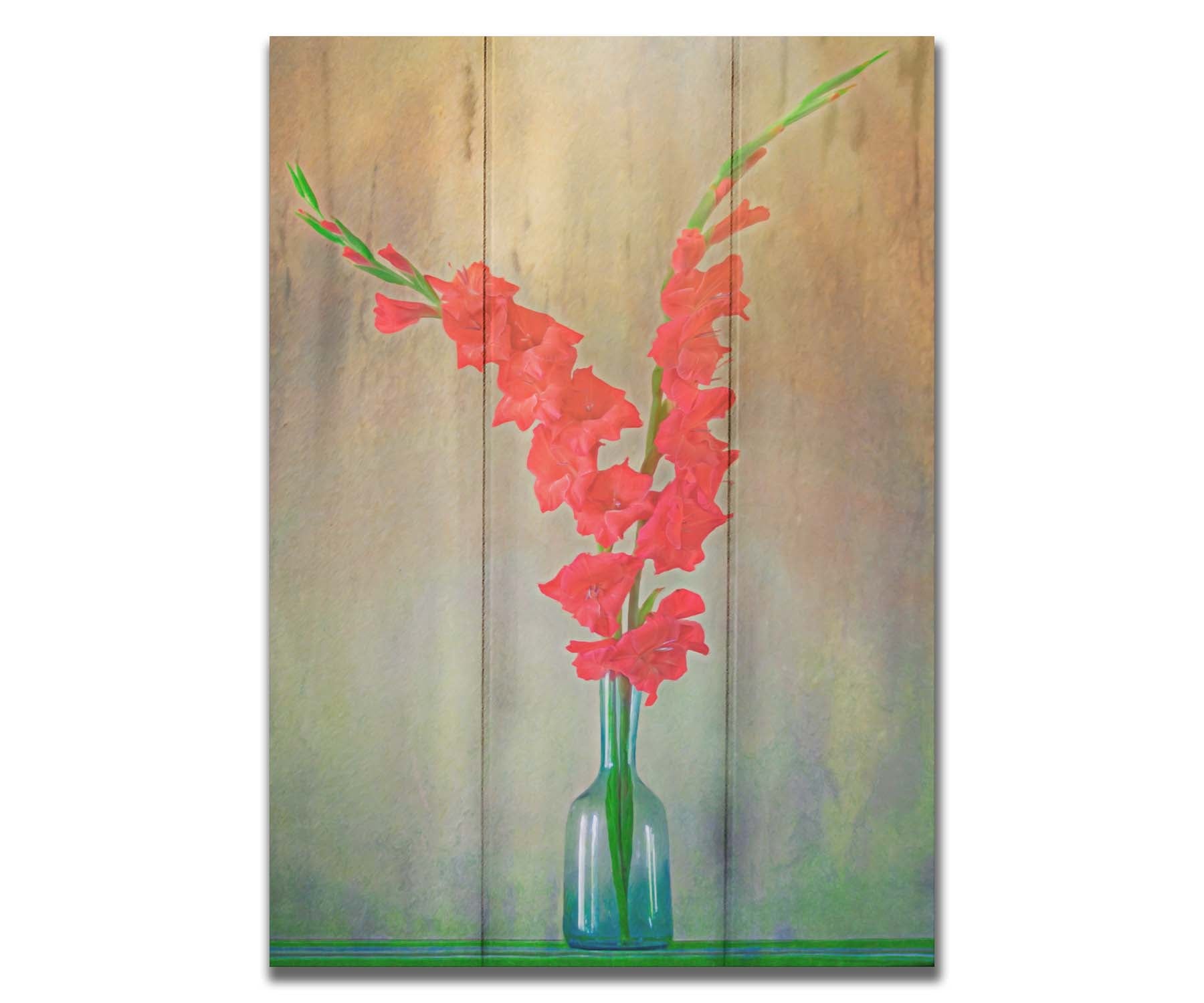 A photo of two red gladiolus flower spikes in a small blue vase. Printed on a box board.