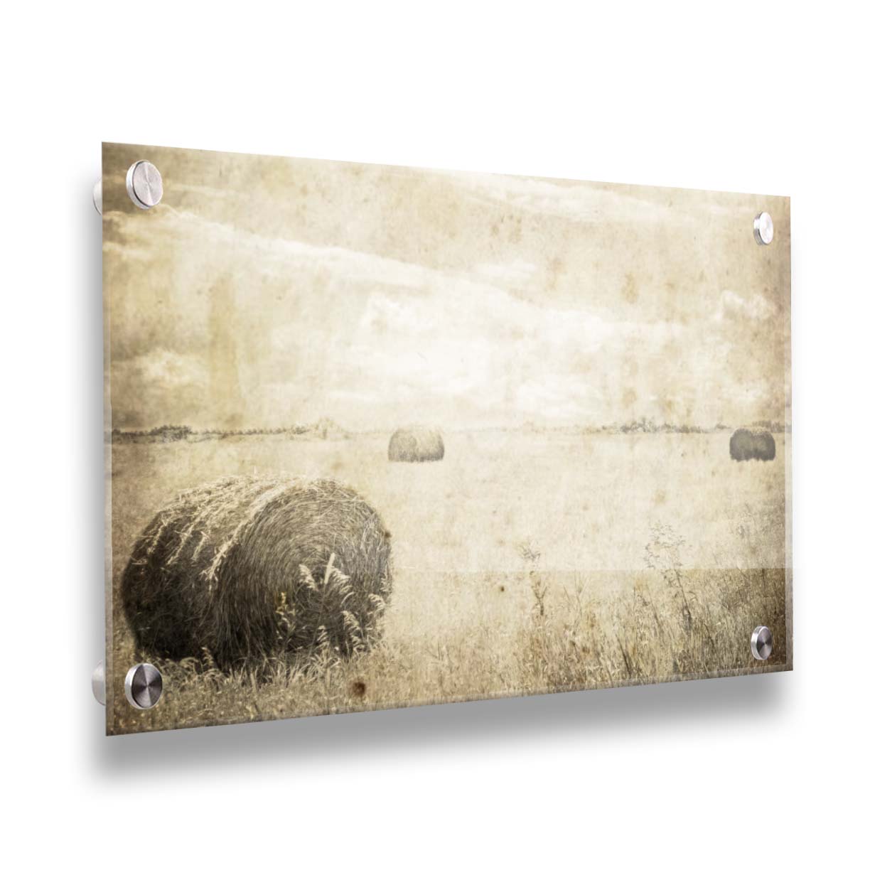 A sepia photo of a wide, open field with several hay bales. Printed on acrylic.