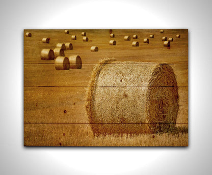 A photo of a field of freshly harvested and baled hay. Printed on a wood pallet.