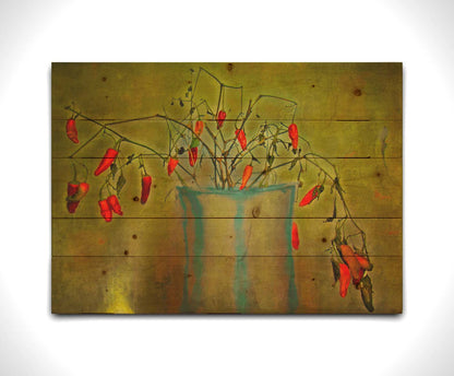 A photo of a pepper plant growing from a white and blue vase, edited with textures to add weathering. Printed on a wood pallet.