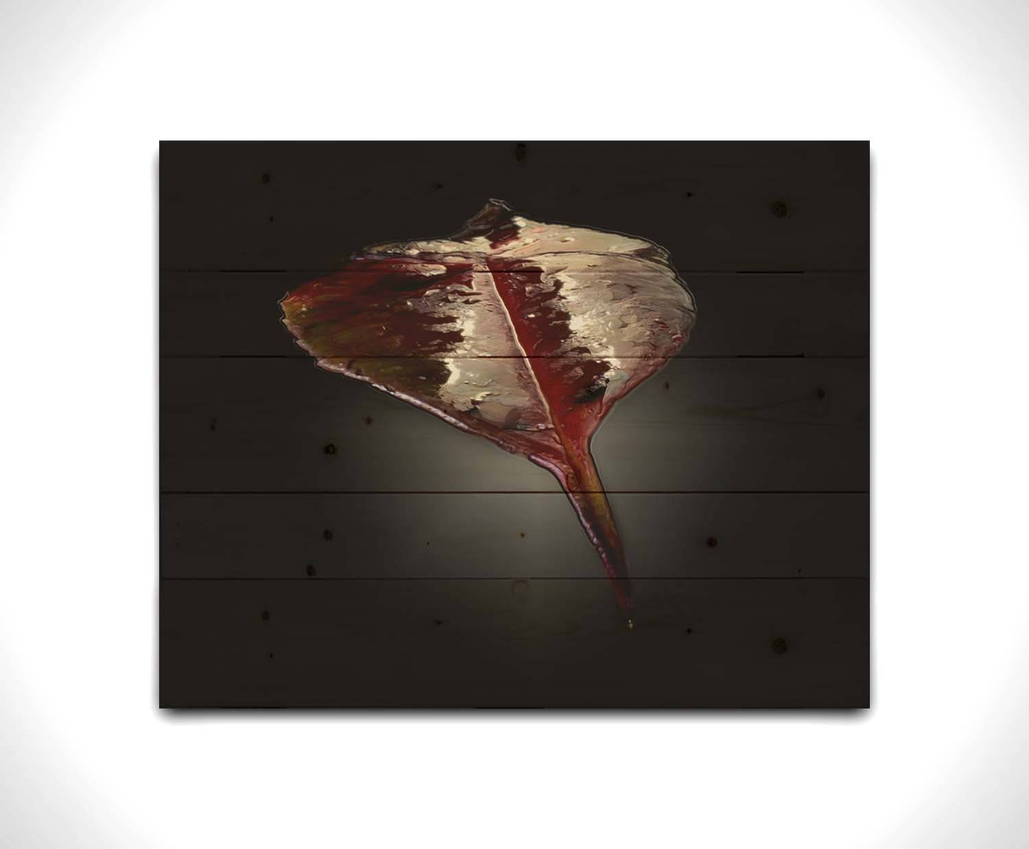 An up-close photo of a red leaf, wet and reflective, isolated on a black background. Printed on a wood pallet.