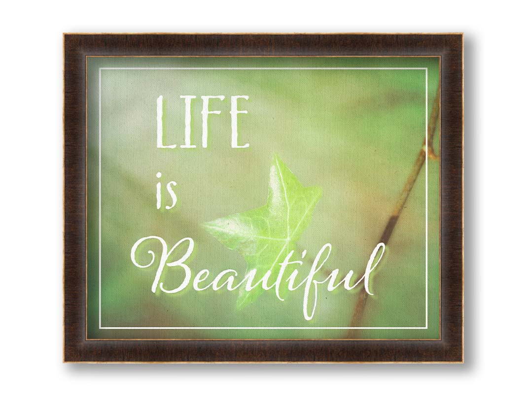 A photograph of a green leaf in soft lighting. The photo is overlaid with white text reading "life is beautiful". Printed on canvas and framed.