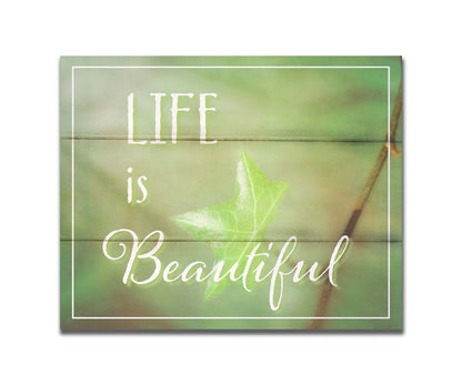 A photograph of a green leaf in soft lighting. The photo is overlaid with white text reading "life is beautiful". Printed on a box board.