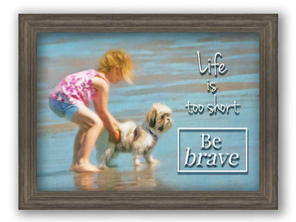 A photograph of a small child and a dog at the beach overlaid with the phrase "life is too short, be brave". Printed on canvas and framed.