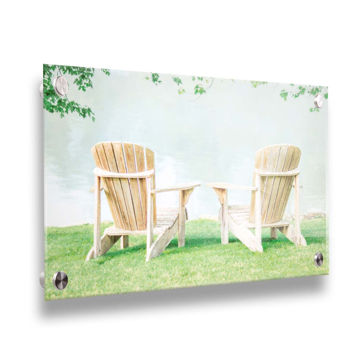 A photo of two wood lawn chairs, sitting on bright green grass, facing a lake. Printed on acrylic.