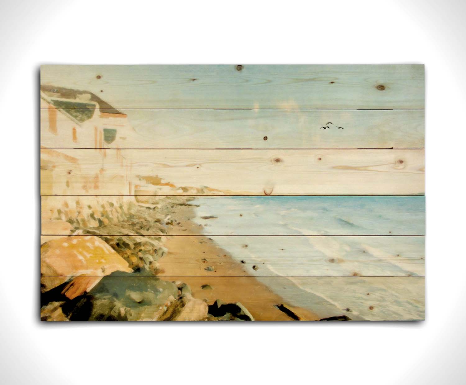 A photo of a beach lined with houses on a calm, sunny day.  Printed on a wood pallet.