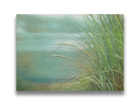 A photo of a tall grass plant on the beach, with the sea and cloudy skies in the background as seagulls fly above. Printed on canvas.