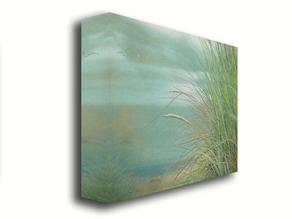 A photo of a tall grass plant on the beach, with the sea and cloudy skies in the background as seagulls fly above. Printed on canvas.