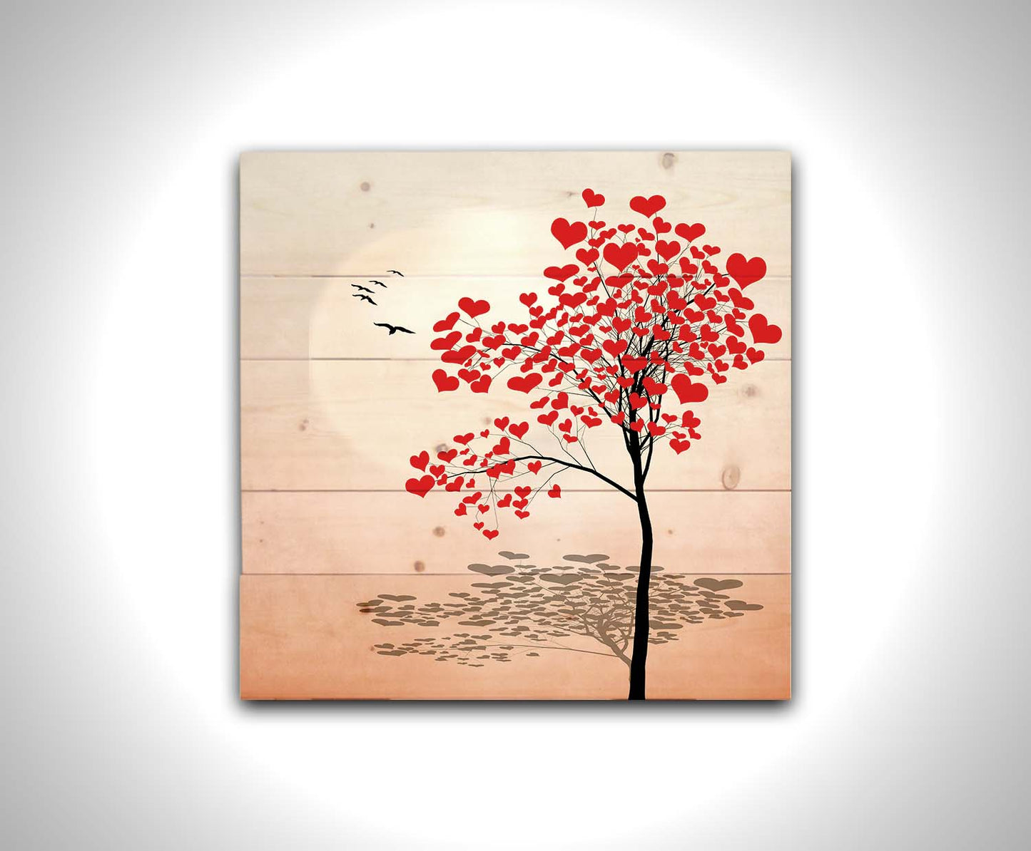 A graphic art depicting a tree with red hearts for leaves, set against a pink and white background. Printed on a wood pallet.