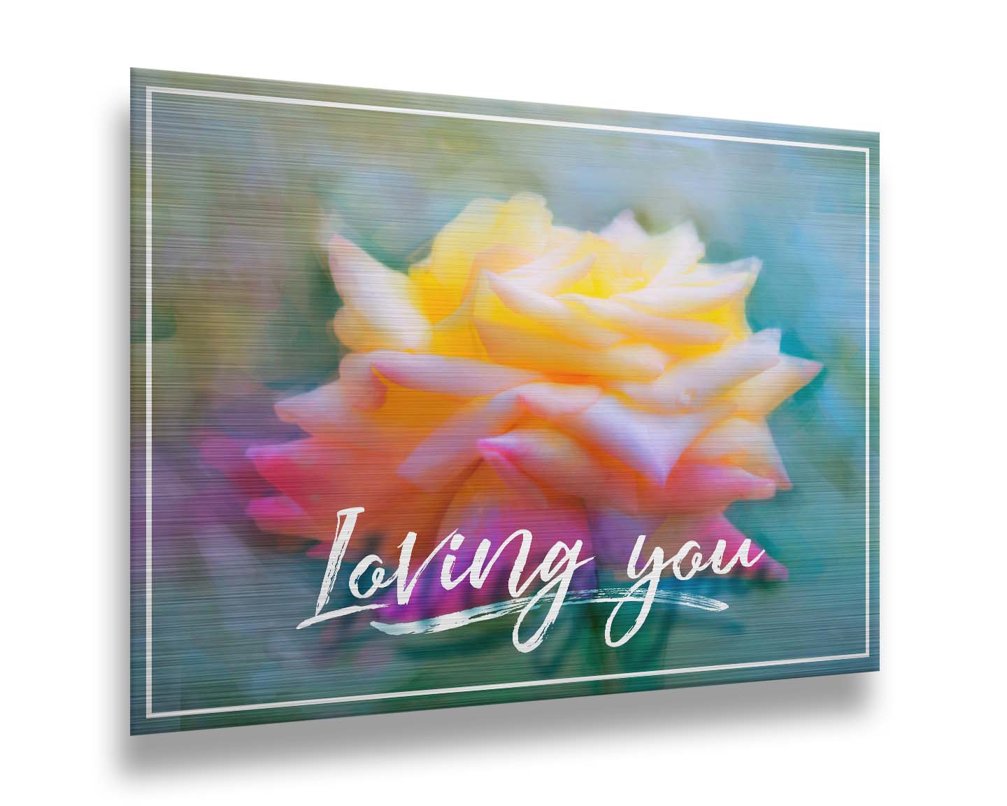 A photo of a pink and yellow rose against a blue background, edited to have a painterly appearance. It is overlaid with a white border and text reading "Loving you." Printed on metal.