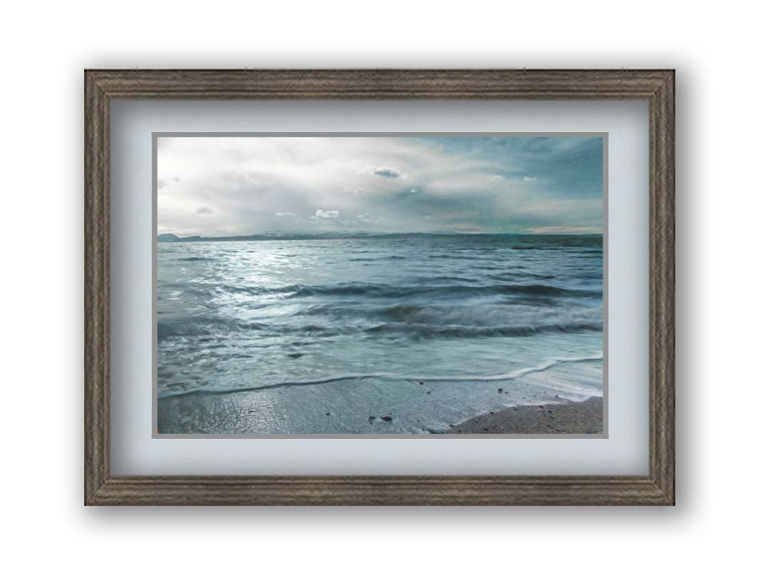 A photo of the sea on a cloudy day, creating a desaturated, stormy look. Printed on paper, matted, and framed.