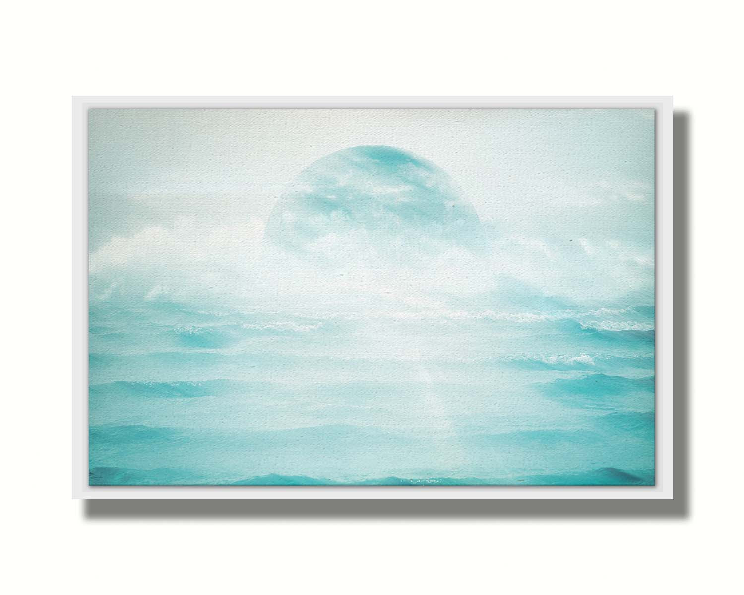 A surreal artistic photography edit of the moon sitting in the ocean. Its light reflects off the water and creates a glow through the fog and clouds just above the water. Printed on canvas in a float frame.