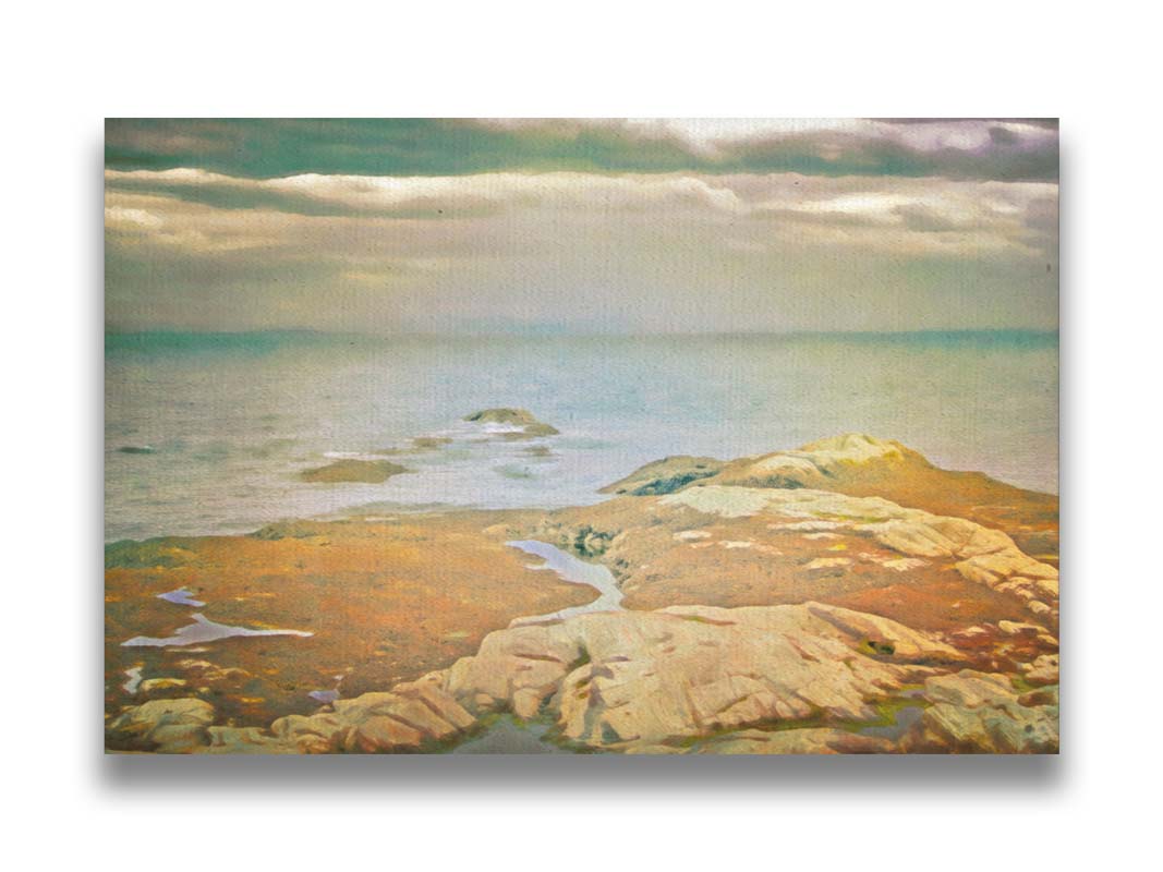 A photo of a stoney shore, looking out to sea under a cloudy sky. Printed on canvas.