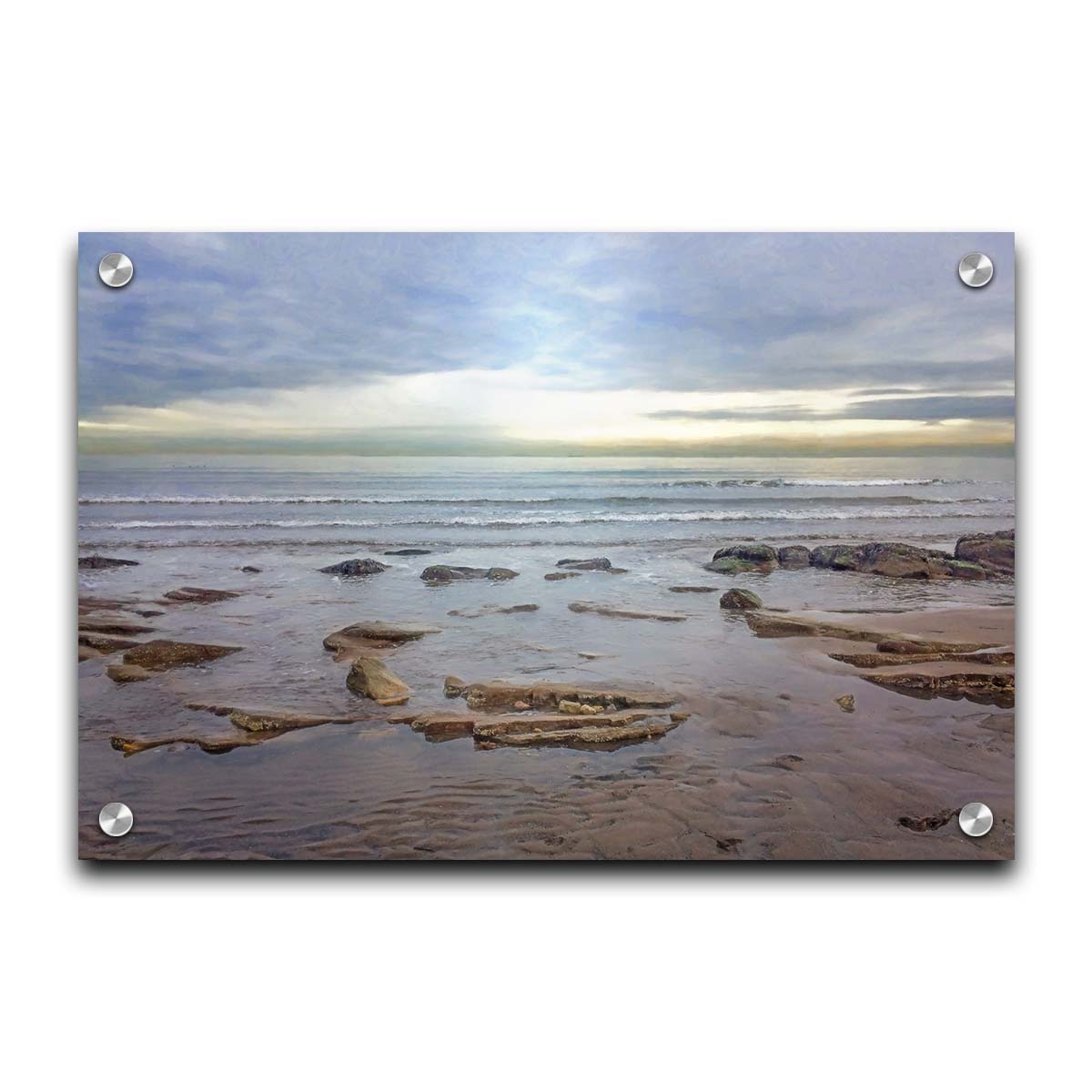 A photograph of the rocky shore of the North Sea at low tide. The sun peeks over the horizon through the partly cloudy sky. Printed on acrylic.