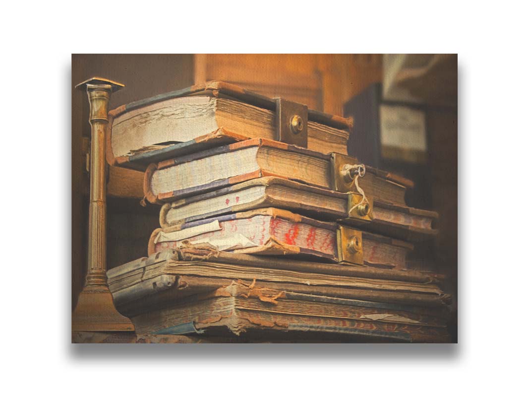 A photo of a stack of worn books, many bound shut by brassy locks. Printed on canvas.