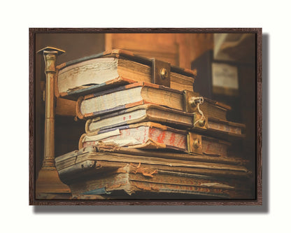 A photo of a stack of worn books, many bound shut by brassy locks. Printed on canvas in a float frame.