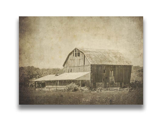 A sepia photo of a large, old, leaning barn. Printed on canvas.