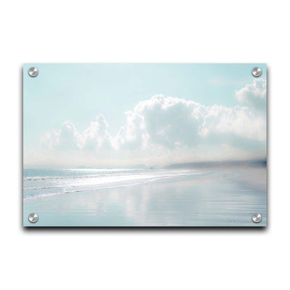 A photo of a beach on a bright but foggy day. The light reflects on the wet sand with the color of the sky,, adding to the dreamlike appearance. A city can be seen through the fog in the distance. Printed on acrylic.