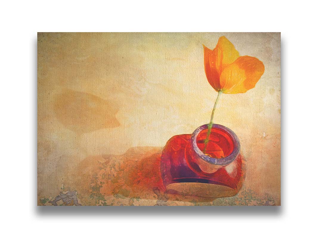 A photo taken from above of a singular orange flower in a red glass bottle. Printed on canvas.