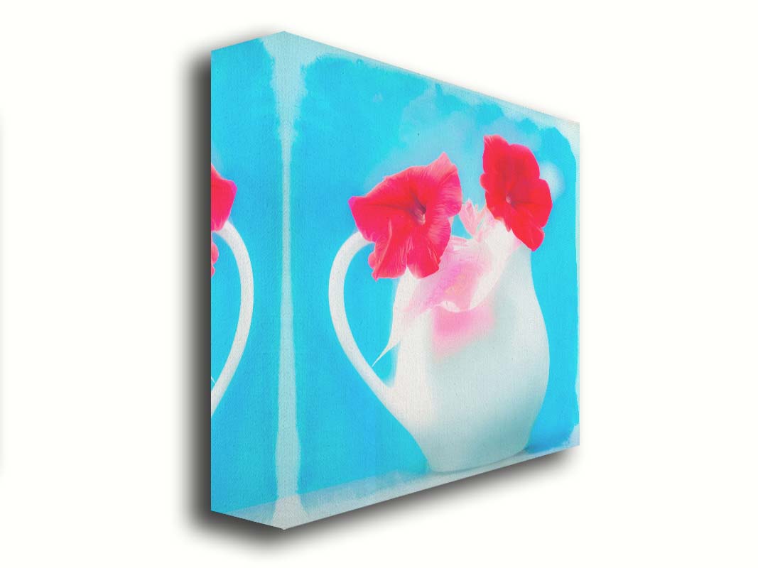 A photo of two red flowes in a white pitcher vase against a cyan backgrround. Printed on canvas.