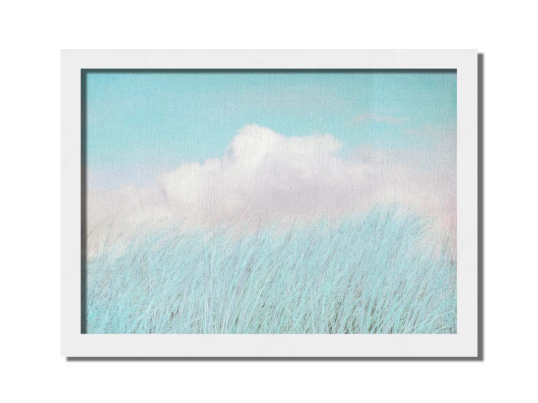 A photo of tall grass under a blue sky with white clouds. Printed on canvas and framed.