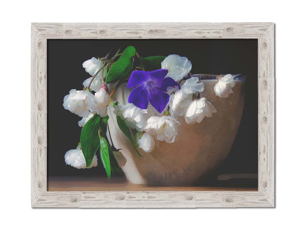 A photo of a brown bowl of white and purple flowers, edited to have a painterly quality. Printed on canvas and framed.