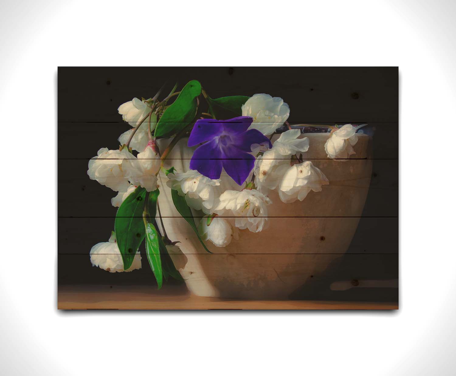 A photo of a brown bowl of white and purple flowers, edited to have a painterly quality. Printed on a wood pallet.