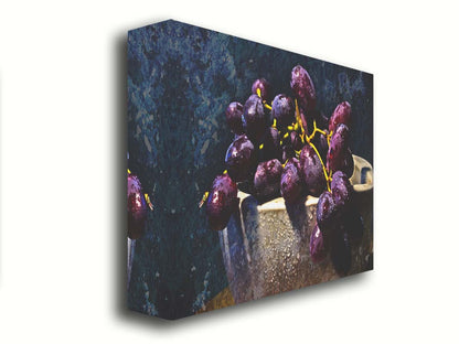 A photo of a bunch of purple grapes in a bowl, covered in drops of water and overlayed with textues. Printed on canvas.