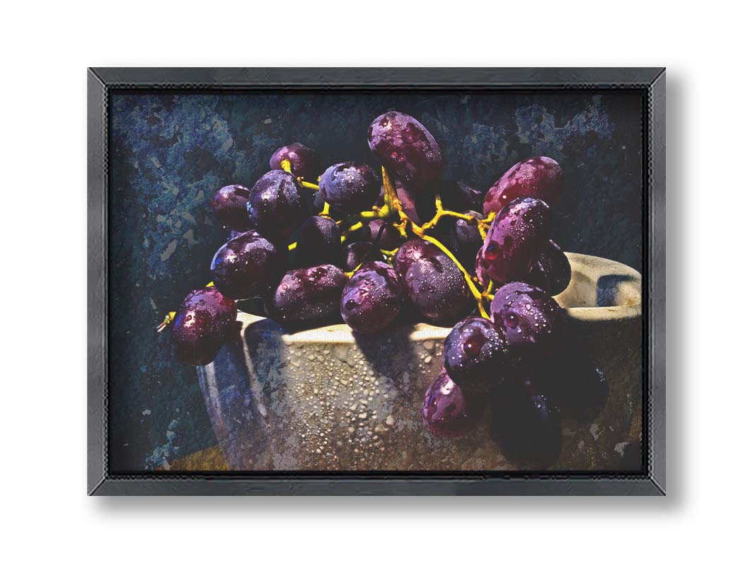 A photo of a bunch of purple grapes in a bowl, covered in drops of water and overlayed with textues. Printed on canvas and framed.