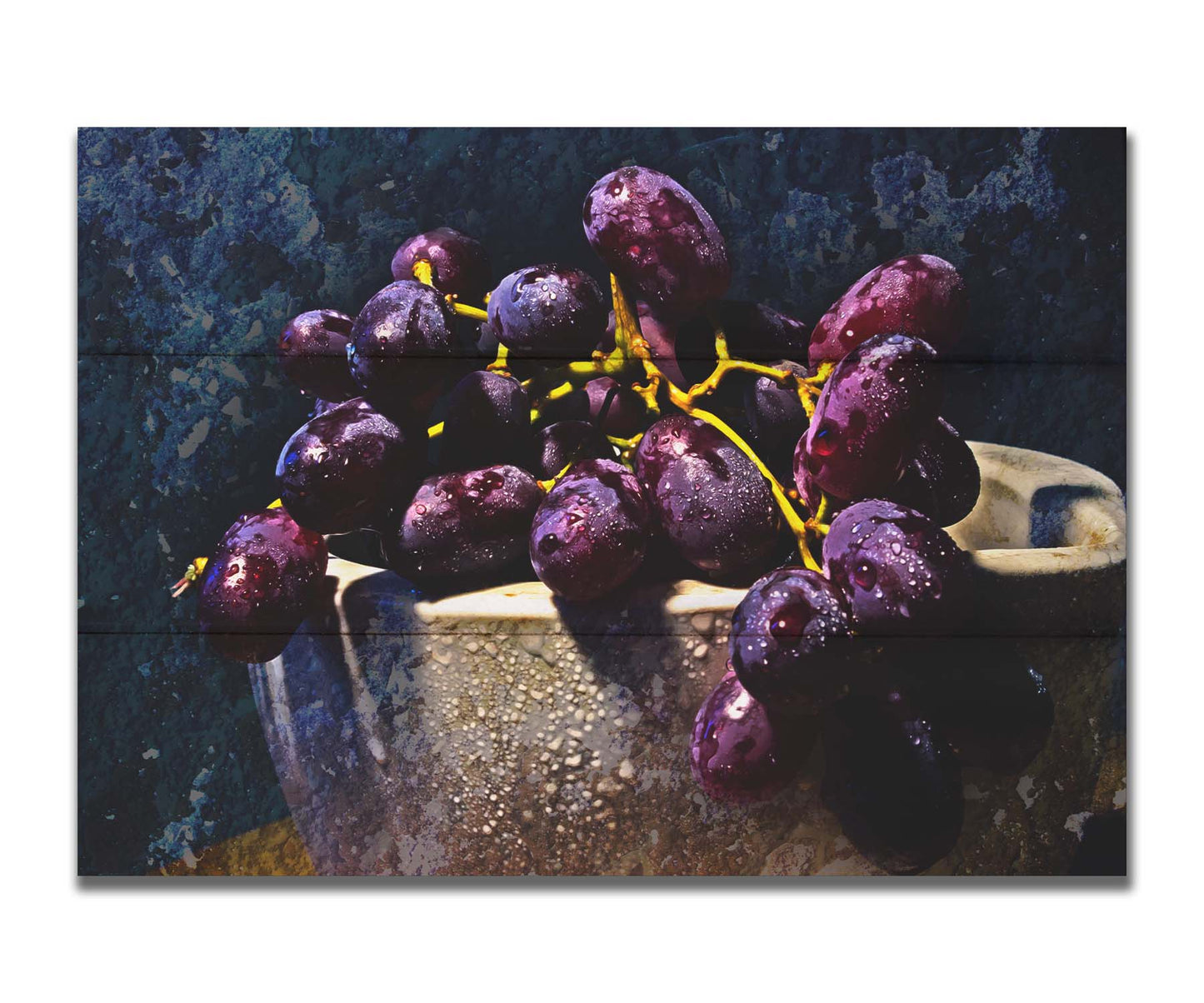 A photo of a bunch of purple grapes in a bowl, covered in drops of water and overlayed with textues. Printed on a box board.