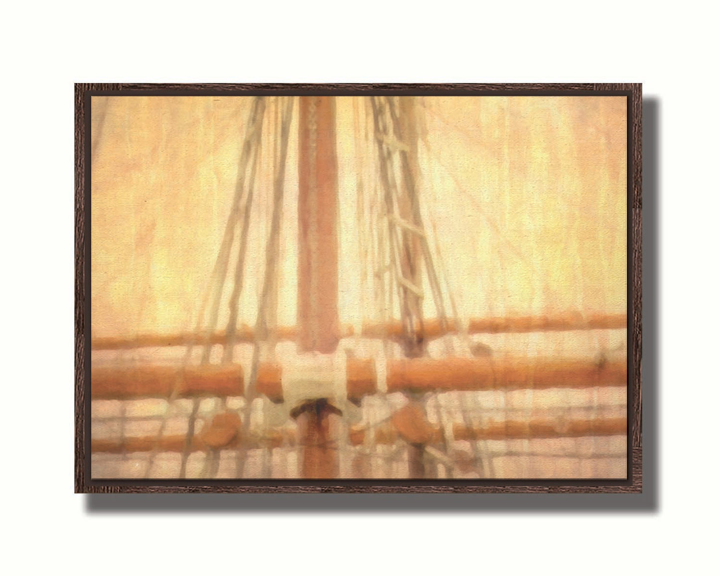 A photo of a ship's rigging against a yellow and orange sky. Printed on canvas in a float frame.