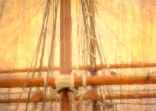 A photo of a ship's rigging against a yellow and orange sky.