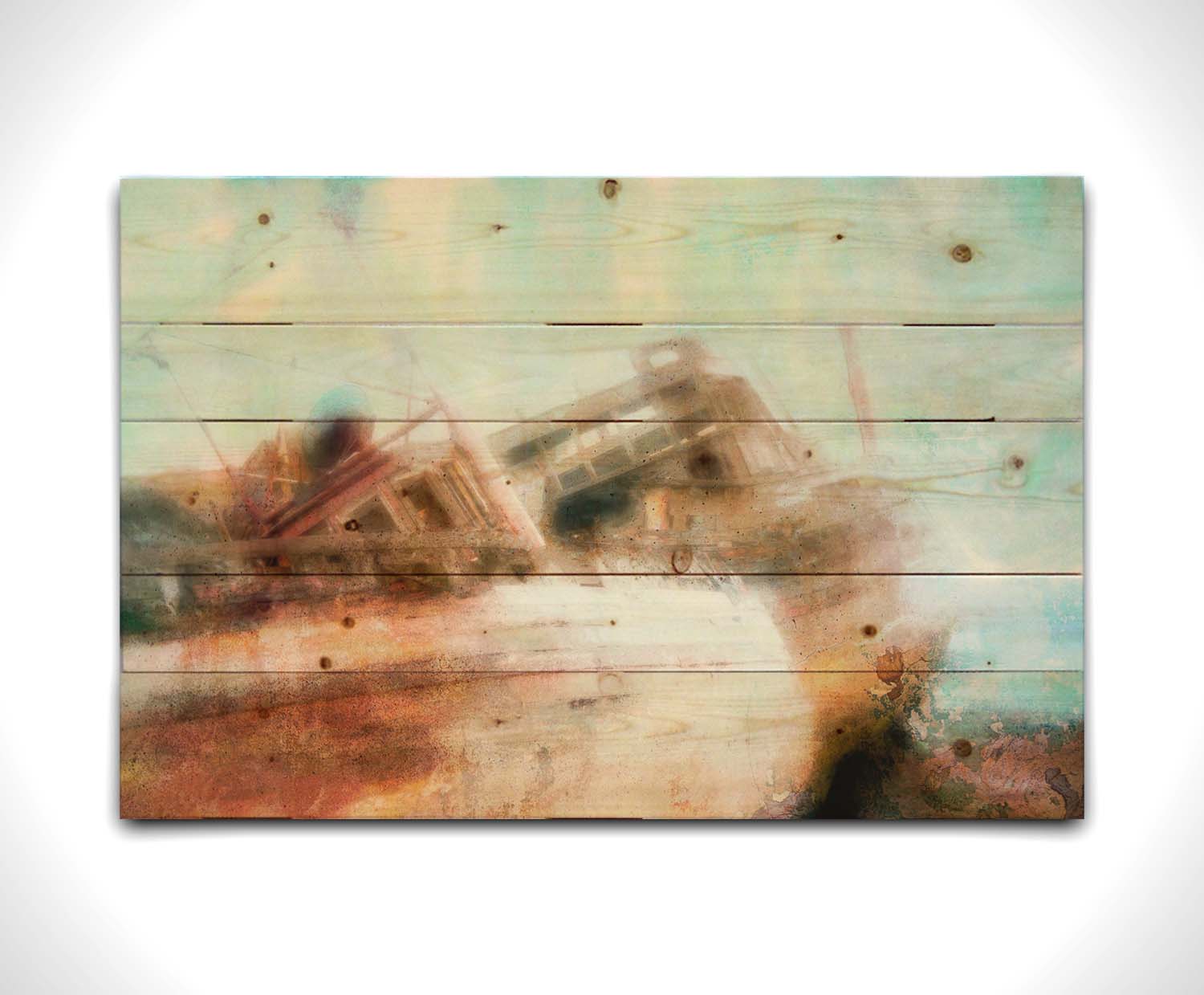 A photo of an old, shipwrecked boat on the beach. Printed on a wood pallet.