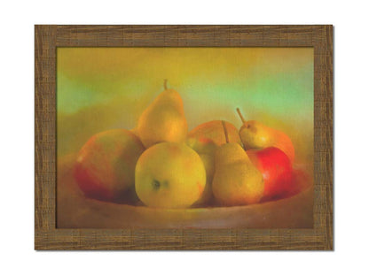 A photo of a dish of apples and pears, in a greenish yellow light. Printed on canvas and framed.