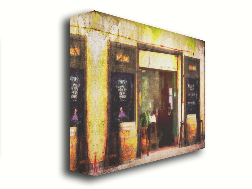 A photo of a rustic restaurant storefront, with barrels outside used as tables. It is edited to have a weathered texture. Printed on canvas.