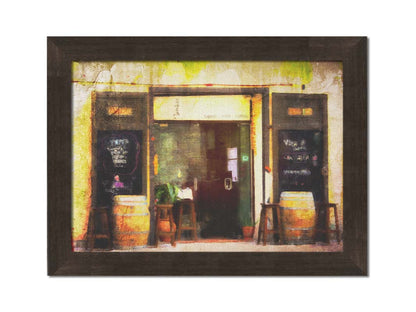 A photo of a rustic restaurant storefront, with barrels outside used as tables. It is edited to have a weathered texture. Printed on canvas and framed.