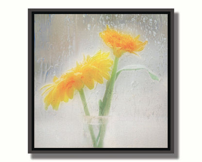 A photo of two yellow flowers in a small glass jar in soft light, edited as viewed through wet glass. Printed on canvas in a float frame.