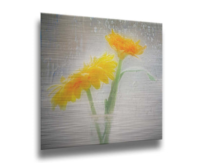 A photo of two yellow flowers in a small glass jar in soft light, edited as viewed through wet glass. Printed on metal.