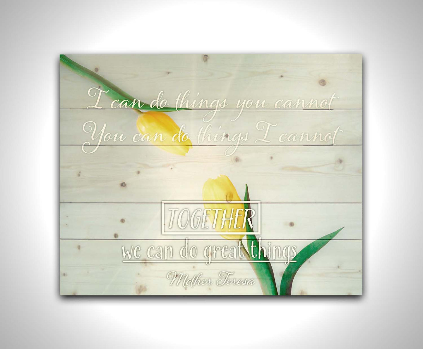 A photograph of two yellow tulips, their petals pointed toward one another. A light shines toward the view from between the tulips. The Mother Teresa quote "I can do things you cannot, you can do things I cannot. Together, we can do great things," is overlaid in white over the photo. Printed on a wood pallet.