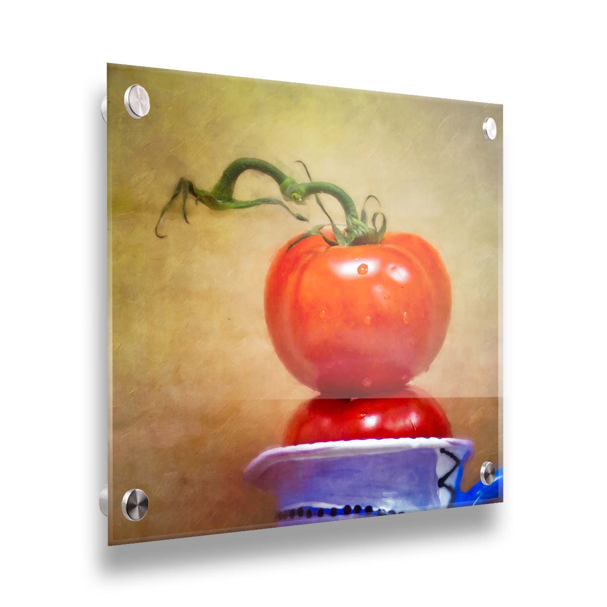 A photograph of bright red tomatoes stacked inside a blue and white ceramic cup, set against a textured neutral background. Printed on acrylic.