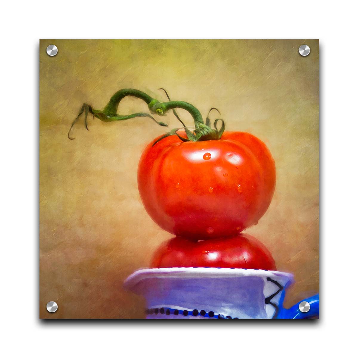 A photograph of bright red tomatoes stacked inside a blue and white ceramic cup, set against a textured neutral background. Printed on acrylic.