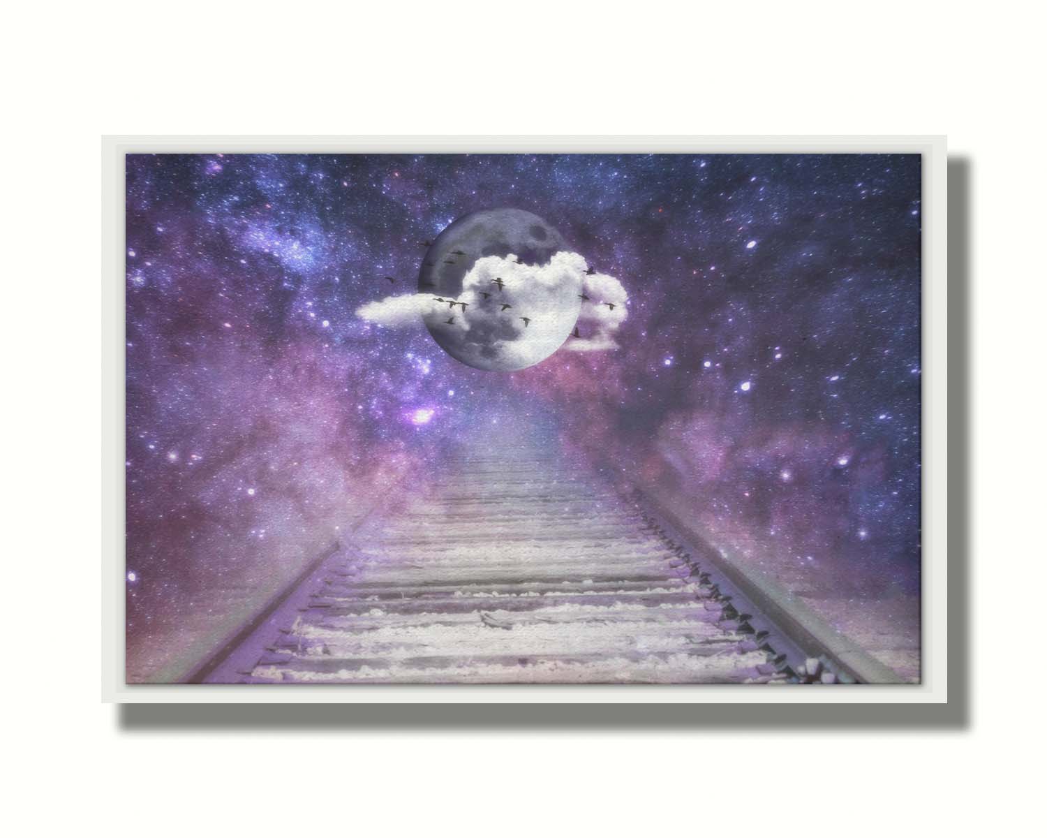 An edited photo looking down train tracks, leading into a starry space view. In the center is a moon surrounded by wispy clouds, with silhouetted geese flying across it. Printed on canvas in a float frame.