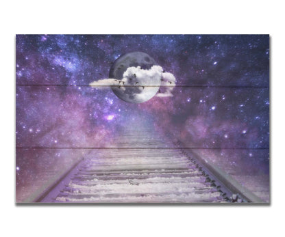 An edited photo looking down train tracks, leading into a starry space view. In the center is a moon surrounded by wispy clouds, with silhouetted geese flying across it. Printed on a box board.