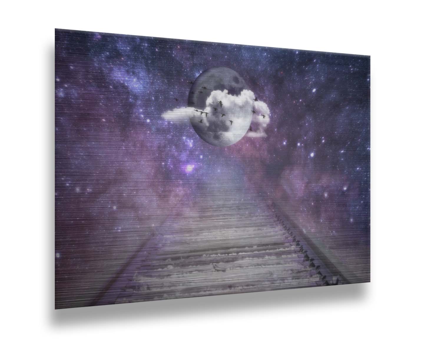 An edited photo looking down train tracks, leading into a starry space view. In the center is a moon surrounded by wispy clouds, with silhouetted geese flying across it. Printed on metal.