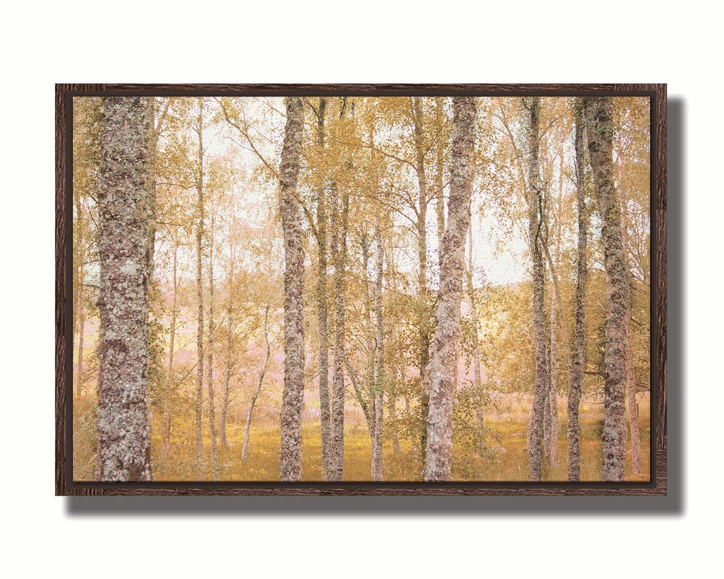 A landscape photo of a forest of yellow autumn trees, edited to be reminiscent of pointilism. Printed on canvas in a float frame.